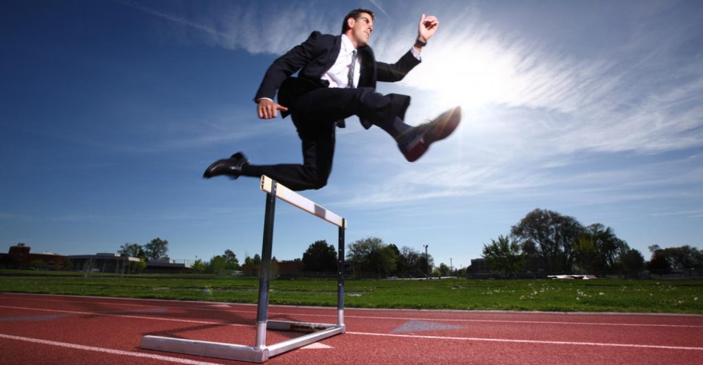 Businessman-jumping-over-hurdle